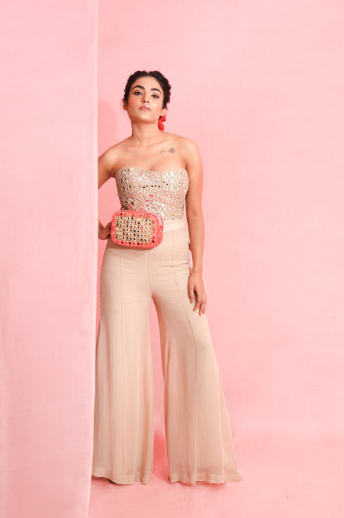 TAMARA : Our Signature style Mirror work Raw silk Corset, teamed up with Beige bell bottoms and a hand embroidered Mirror work and chain detailed Belt bag
